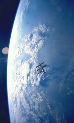 an airplane flying over the earth in space