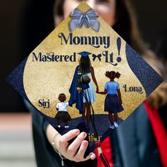 a woman holding a graduation cap with the words mommy, master and child on it