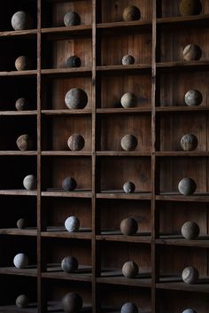 a wooden shelf filled with lots of balls