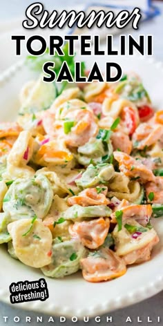 a white plate topped with pasta and shrimp