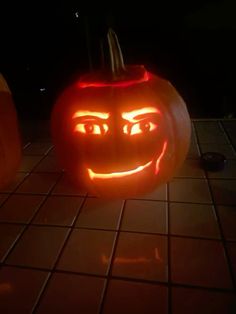 two pumpkins with faces carved into them