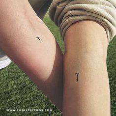 a person with a small tattoo on their arm holding onto a tennis racquet