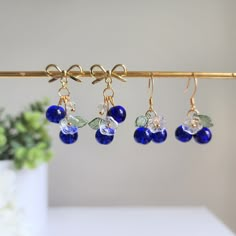 Our sweet blueberry cluster earrings are made with glass berries, glass flowers, crystal beads and 14K gold plated earring hooks which are great for delicate ears. It comes with beautiful eco-friendly wrapping, makes for a great gift. We also have silver version available. Please contact us for details!Size: The long version (W x L) is about 1.5 cm x 3.2 cm The short version (W x L) is about 1.5 cm x 2 cm Beaded Cluster Earrings, Blueberry Fashion, Blueberry Jewelry, Blueberry Earrings, Blueberry Festival, Cute Blueberry, Handmade Earrings Ideas, Fruit Blueberry, Wedding Fruit