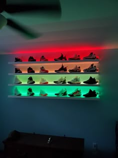 a wall mounted shelf filled with lots of different types of shoes on top of it