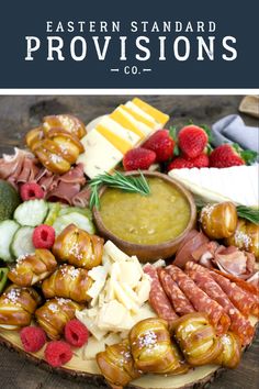 a platter filled with meats, cheese and fruit