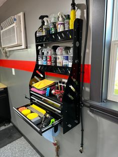 an organized shelf in the corner of a room with tools and other items on it