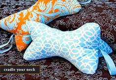 two decorative pillows on a bed with the words cradle your neck written below them in blue and orange