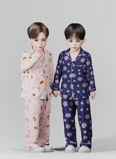 two children in pajamas standing next to each other