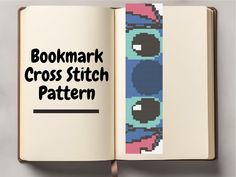 the bookmark cross stitch pattern is in an open book