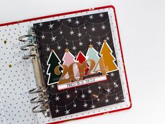 a notebook with christmas trees and the number twenty on it