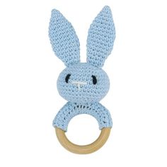 a crocheted blue bunny ring rattler on a white background with a wooden handle