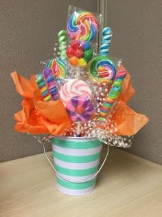 a bucket filled with candy and candies on top of a table