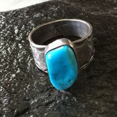 Navajo Turquoise Stone Ring In Raised Bezel Setting. Wide Width 1/2” Band Has Great Scalloped Stamping Design. Attractive Design, Handcrafted And Signed By The Artist Lly. Stone Is 3/4” X 3/8” Please Use The Photos For More Ring Details The Turquoise Stone Is Fractured But Stable. The Ring Would List At $149 But Is Priced Lower Due To The Fracture Size 11 9.29 Grams Weight Stamped Sterling Hallmark Lly Native American Never Worn Condition From Vintage 80’s Collection Turquoise Stone Ring, Native American Rings, Navajo Turquoise, Vintage Navajo, Stamp Design, Stone Ring, Turquoise Stone, Womens Jewelry Rings, Bezel Setting