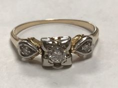 Vintage 14k Gold Diamond Pre-Engagement Promise Ring Size 6.5 A truly superb vintage ring, crafted beautifully in solid 14K gold.  Great worn as a pre-engagement ring or a right hand ring.  In BEAUTIFUL original condition. * Weight: 1.9 grams * Stones: 1 -.20ct round diamond is set into the center mount. There are 2 - .4ct round diamonds on each side of band. * Size & Measurements: The ring is approximately a size 6.5 Will ship in a gift box Vintage Yellow Gold Rings With Diamond Accents, Vintage Yellow Gold Wedding Rings With Diamond Accents, Vintage 14k Gold Promise Ring, Vintage Diamond Ring With Center Stone For Promise, Vintage Solitaire Diamond Ring For Anniversary, Vintage Diamond Ring With Center Stone For Anniversary, Vintage Diamond Promise Ring With Center Stone, Vintage Promise Ring With Center Stone, Vintage Anniversary Diamond Ring With Center Stone