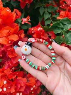 Adorable snowman holiday styled bracelet ❤️ This Christmas themed bracelet is made with red, green, and white 6mm heishi beads, acrylic red heart beads, red seed beads & a ceramic snowman charm  What a better way to spread some cheer? This bracelet is a wonderful accessory for the holidays! ✨ stack it with other jewelry or wear it alone! Gift it to someone special or rock it yourself 💞 (You will receive one snowman bracelet. Not identical to bracelet shown in pic but very similar!) Snowman Accessories, Ceramic Snowman, Heishi Bracelet, Bracelet Christmas, Christmas Bracelet, Christmas Accessories, Crystal Beads Bracelet, Holiday Jewelry, Heishi Beads