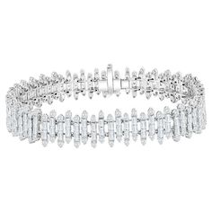 Diamond tennis bracelet set in 18K white gold. The bracelet is set with tapered baguettes and round stones. The color of the stones are F, the clarity is VS1-VS2. The total weight is 9.45 carats. Luxury Diamond Tennis Bracelet With Baguette Diamonds, Luxury Diamond White Bracelet With Baguette Diamonds, White Baguette Diamond Tennis Bracelet, Elegant Diamond White Baguette Cut Tennis Bracelet, Luxury Dazzling Baguette Cut Tennis Bracelet, Luxury Silver Baguette Cut Tennis Bracelet, Silver Baguette-cut Diamond Tennis Bracelet, Formal Vvs Clarity Baguette-cut Diamond Bracelet, Baguette Bracelet