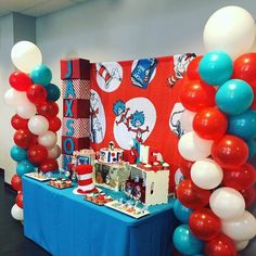 the dr seuss birthday party is set up with balloons