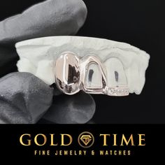 gold time fine jewelry & watches logo on black background with white gloves and grey cloth