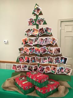 a christmas tree made out of photos and pictures is displayed on a table with green cloth