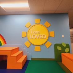 the children's playroom has an i am loved sign on the wall