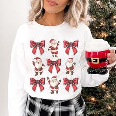 🎄Santa Bow Sweatshirt  Perfect for spreading Christmas cheer and adding a touch of whimsy to your holiday wardrobe. IMPORTANT Mockups are used for demonstration purposes only, and the final product may vary slightly in color & placement. ❣️SIZE & FIT: Gildan 18000 Unisex Sweatshirt  True to size with a relaxed fit **Size up 1 or 2 if you like an oversized fit. Design is scaled down on smaller sizes. THESE ARE UNISEX SIZING 💌 CARE INSTRUCTIONS: * Wash inside out, in cold water, on gentle cycle. Tumble dry low or let air dry * Do not use Fabric Softeners or Bleach * Do not dry clean. *Avoid ironing on the design. 📦SHIPPING: Once order is placed production takes 1 to 3 days. Standard Shipping 3-5 business days after production time. USPS does experience rerouting and delays from time to ti Coquette Sweater, Holiday Party Tops, Spreading Christmas Cheer, Bow Sweatshirt, Christmas Coquette, Pink Santa, Santa Sweatshirt, Holiday Wardrobe, Vintage Santa