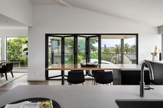 an open kitchen and dining room with sliding glass doors