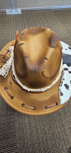 Custom burned fedora hat.  Hat is darker than photo shows.   Decorated with fabric, feathers, beads, leather and wood burning tool.  One size fits most and this hat is adjustable.  Hats are handmade by myself. Message me with any questions you might have.  I am happy to help in any way.  Thank you for shopping small business. Western Brown Mini Fedora Hat, Western Style Brown Mini Hats For Festival, Brown Western Mini Hats For Festivals, Handmade Country Style Top Hat For Country Events, Western Fedora Mini Hats For Western-themed Events, Handmade Western Costume Hats And Headpieces For Rodeo, Handmade Western Costume Hats And Headpieces For Western-themed Events, Handmade Western Costume Hats And Headpieces, Handmade Brimmed Hat For Western-themed Events