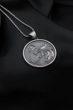 Silver School of Wolf Medallion from The Witcher series, adapted from the book into video games, TV series and animation. Silver Witcher Medallions are waiting for you with 3 different types. Perfect for cosplay and incredible gift for every Witcher fan. It is ideal for daily use with 925 sterling silver, which makes details more attractive eye-catching. It's the perfect Christmas gift, a thoughtful anniversary gift, and a flattering graduation gift. Angelios is here to help you on all your spec Black Fandom Jewelry Gift, Black Fandom Inspired Jewelry Gift, Fandom Style Black Jewelry Gift, Witcher Medallion, Greek Mythology Jewelry, Mens Birthday, Birthday Pendant, Attractive Eyes, Wolf Necklace