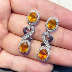 ENJOY OUR WORRY-FREE SERVICE AND THE DAZZLING, GENUINE JEWELRY WE DESIGN AND HANDCRAFT WITH LOVE❤️ ABOUT THE ITEM: SPARKLING! SHIMMERING, DANGLING VIVID ORANGE YELLOW SAPPHIRE EARRINGS! SO PRECIOUS! CERTIFIED 12.68 Total Carats, with 4 pieces of Thai yellow sapphires and 1.21 carats of F/VS, natural diamonds, set in handmade 10.0 grams, 18K solid white gold, CHIC dangling earrings. One of a kind! At 3.6 centimeter in drop length, perfect for both formal and causal events! ONE OF A KIND HANDCRAFT Yellow Oval Fine Jewelry Earrings, Yellow Oval Earrings In Fine Jewelry Style, Yellow Oval Earrings Fine Jewelry, Yellow Oval Gemstone Earrings, Fine Jewelry Oval Earrings With High Luster, White Gold Pendant Necklace, Golden South Sea Pearls, Blue Sapphire Diamond, Solid Gold Earrings