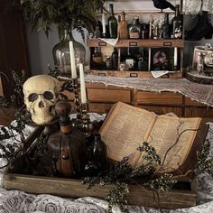 there is a skull sitting on top of an open book in the middle of a table