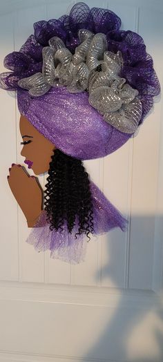 a purple hat with silver sequins is hanging on a door handle and it's made out of mesh