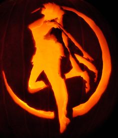 a carved pumpkin with the silhouette of a person on it