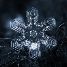 a snowflake that looks like it is made out of ice and has been placed in the grass