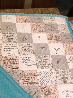 a quilted blanket with writing on it