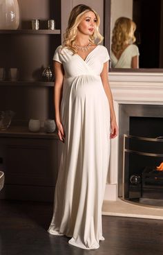 Sleek and elegant, our Francesca Wedding Gown in dreamy ivory white glides over your pregnancy curves in luxurious soft-sheen jersey. With a crossover neckline and grow-on sleeves that can be worn on or off-the-shoulder, this maternity dress fits and flatters in all the right places. Ivory white luxe jersey with subtle sheen Flattering cross-over neckline Stretch for comfort Floaty full-length skirt Fully lined Perfect for all stages of pregnancy Made in Britain Pregnancy Gowns Dresses Tiffany Rose Maternity, Wedding Dresses For Pregnant Brides Tiffany Rose Maternity, Rose Tiffany, Estilo Meghan Markle, Foral Dress, Spring Wedding Outfit, Dressing Table Ideas, Pregnant Bride, Tiffany Rose