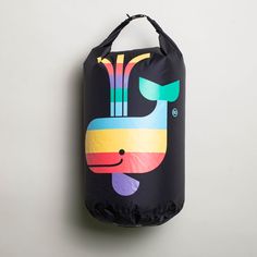 a black bag hanging on the wall with a colorful whale design painted on it's side