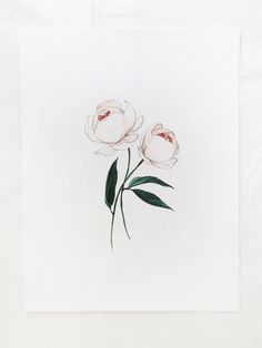 two pink flowers on a white paper with green leaves