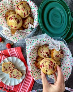 two plates with muffins in them on a table next to red and green napkins