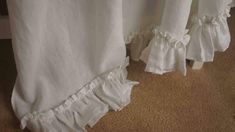 white curtains with ruffles hanging from them