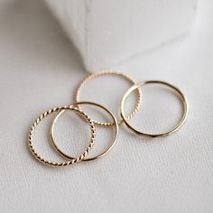 The Glimmer Ring gives you the ideal glitter for your ring stack. The hammered Glimmer Ring is the perfect addition of texture to any stack and is overflowing with simplicity and shine! You have so many options with this one. Wear it on its own, stack it with your other favorite CTWF pieces, or even stack three up on their own for major extra shine and shimmer. The Glimmer Ring is the perfect understated look for everyday wear. Yellow Gold Hammered Stackable Rings, Delicate Hammered Yellow Gold Ring, Gold Hammered Stackable Round Band Rings, Gold Hammered Stackable Rings, Gold Stackable Rings With Diamond Cut In Recycled Gold, Hammered Recycled Gold Stackable Rings, Hammered Stackable Rings In Recycled Gold, Gold Minimalist Stackable Rings With Diamond Cut, Minimalist Gold Stackable Rings With Diamond Cut