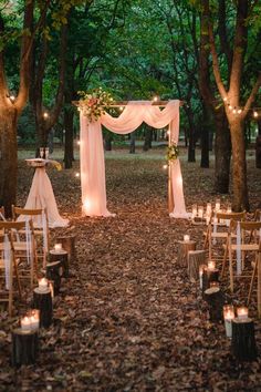 an outdoor wedding set up in the woods