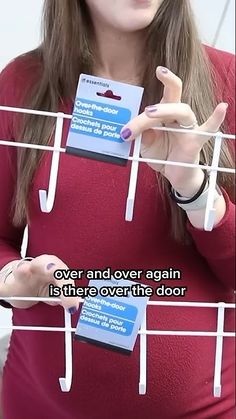 a woman is holding up some clothes pins