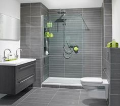 a bathroom with gray tiles and white fixtures