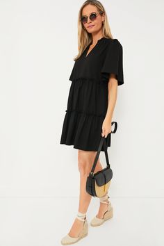 The Black Crepe Crawford Dress is exactly what we have been searching for — that perfect warm weather piece that you can throw on for morning cappuccinos and wear until cocktail hour. Featuring oversized flutter sleeves, ruffle detailing on the neckline and skirt, and a swing silhouette in a timeless color, this mini is the most flattering and flirty frock. Effortlessly whisking you from work to play, pair with sneakers and sunnies for a casual look then switch to wedges and statement earrings f Cocktail Hour, Mini Me, Flutter Sleeve, Warm Weather, Statement Earrings, Sunnies, Casual Looks, Black Dress, How To Wear