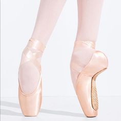 the feet of a ballerina in pink ballet shoes