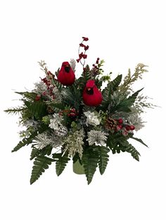 a vase filled with red flowers and greenery