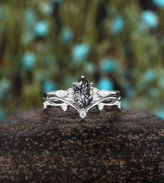 a diamond ring sitting on top of a rock