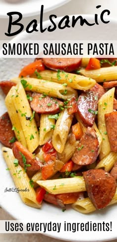 this is an image of pasta with sausage and tomato sauce in a white bowl on a table