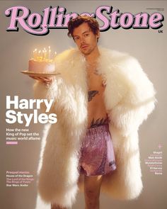 a man is holding a birthday cake on the cover of rolling stone's magazine