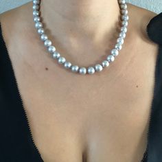 Freshwater Silver-Grey Bridal Pearl Necklace. This beautiful necklace is the epitome of class. One stand of gorgeous silvery grey pearls, hand strung and individually knotted. Quality pearl necklaces are always knotted between the pearls. This protects the pearls from rubbing together and becoming damaged. All pearls are natural and genuine. PEARL SIZE: 9.5-10.5 PEARL SHAPE: Round PEARL COLOR: Silvery Grey NECKLACE LENGTH: 18 inch CLASP: Sterling Silver Toggle Clasp Shipping is free on all domes Gray Pearl Necklace For Gifts, Gray Pearl Necklace For Gift, Silver Single Strand Tahitian Pearl Necklace, Gray Pearl Necklace For Formal Occasions, Gray Round Pearl Jewelry, Gray Round Necklace For Formal Occasions, Elegant Gray Necklace For Wedding, Formal Gray Pearl Necklace, Formal Gray Tahitian Pearl Jewelry